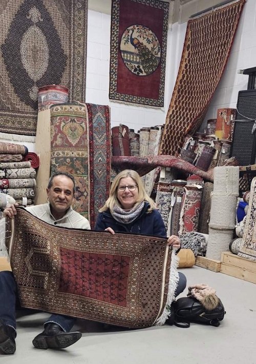 client Lisa with Hamid holding a Persian rug