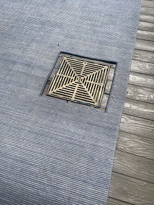 After cutting and binding an area on rug to accommodate water drain